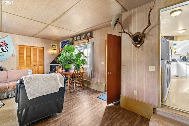 living room with wood ceiling, wooden walls, and wood-type flooring