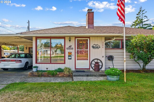 view of front facade featuring a carport and a front yard