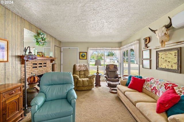 living room with wooden walls, carpet flooring, a wall mounted AC, a brick fireplace, and a textured ceiling