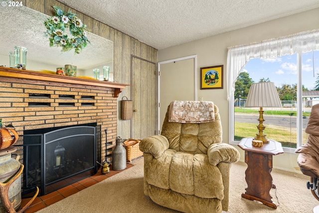 sitting room featuring a fireplace, carpet, and a textured ceiling