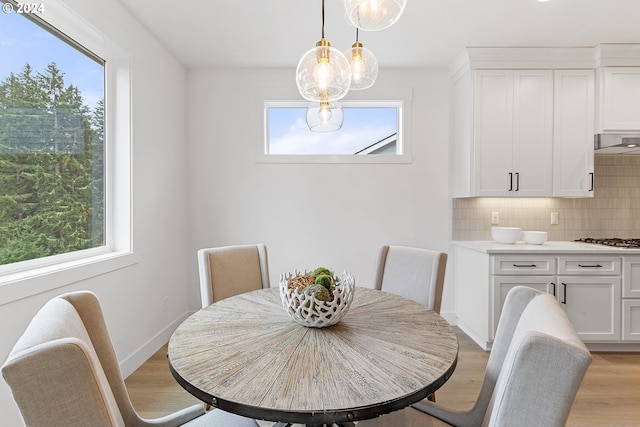 dining space with plenty of natural light and light wood-type flooring