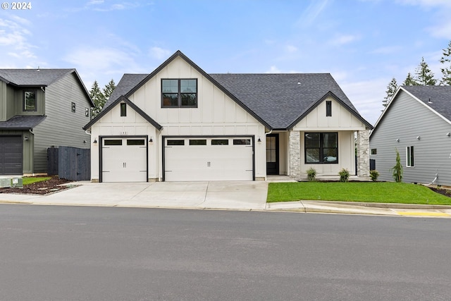 modern farmhouse style home with a garage and a front yard