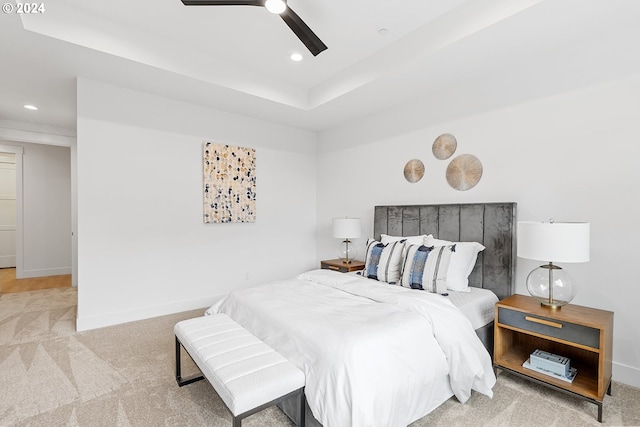 bedroom with ceiling fan and light carpet