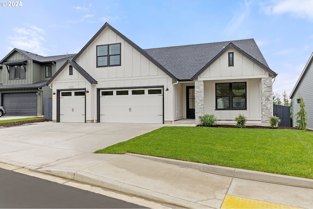 modern farmhouse with a front lawn and a garage