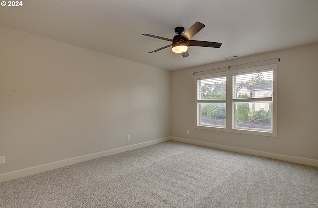 spare room featuring carpet and ceiling fan