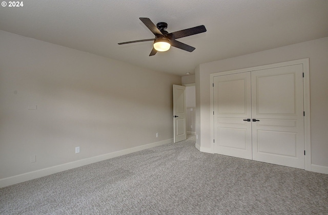 unfurnished bedroom featuring ceiling fan, a closet, and carpet floors