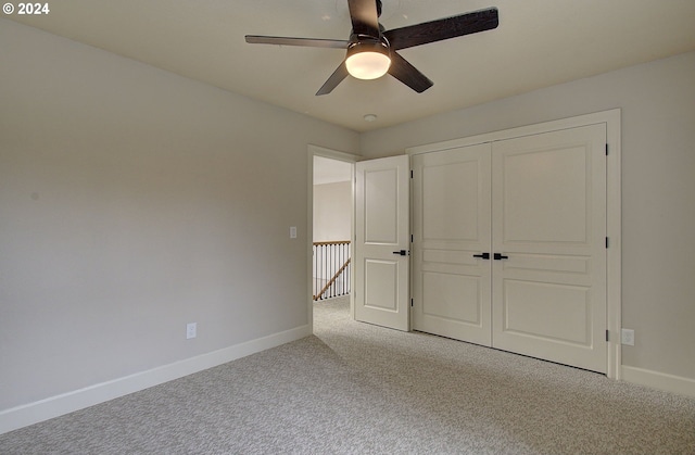 unfurnished bedroom with ceiling fan, a closet, and carpet