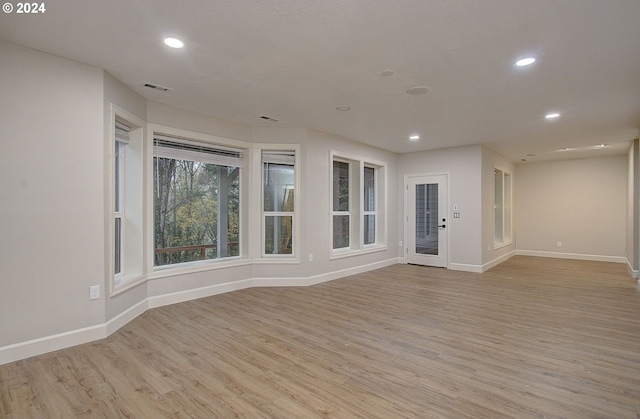 unfurnished room with light hardwood / wood-style flooring