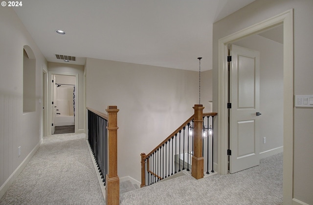 corridor with light colored carpet