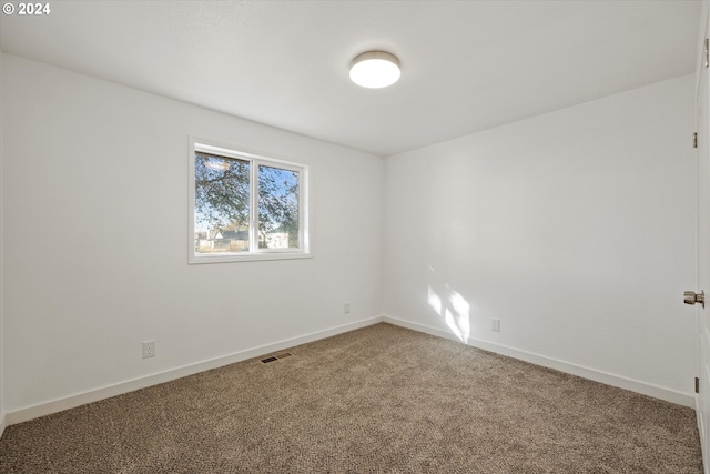 unfurnished room featuring carpet