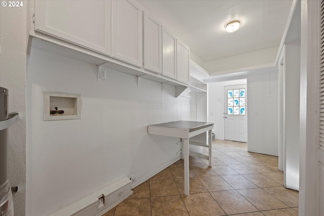 washroom featuring washer hookup, cabinets, and light tile patterned floors