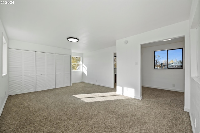 unfurnished bedroom with a closet and carpet floors