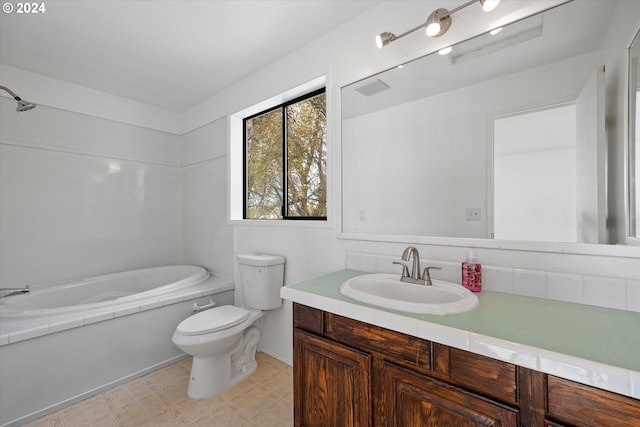 bathroom with toilet, vanity, and a tub