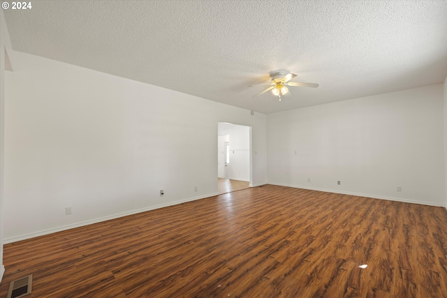 unfurnished room with dark hardwood / wood-style flooring, a textured ceiling, and ceiling fan