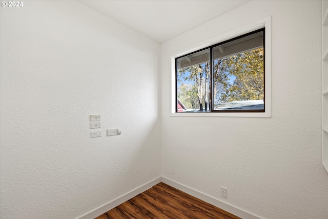 unfurnished room with dark hardwood / wood-style flooring