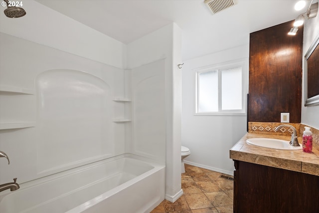 full bathroom with vanity, toilet, and  shower combination