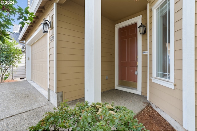 doorway to property with a garage