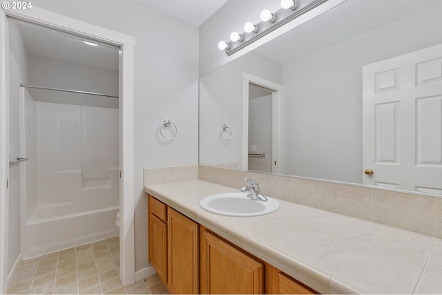 full bathroom with toilet, vanity, and  shower combination