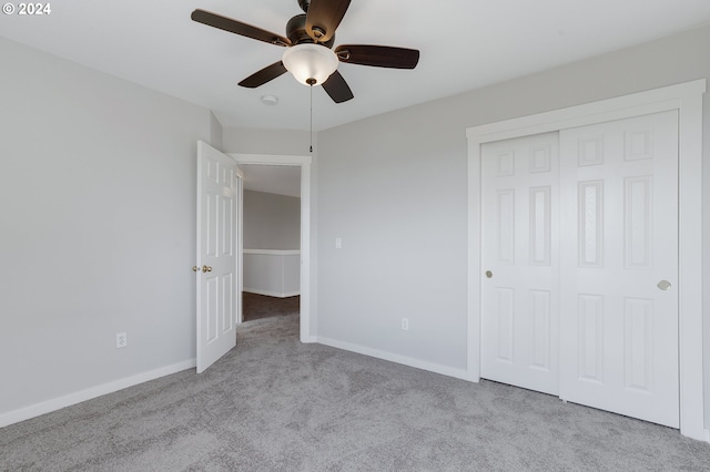 unfurnished bedroom featuring light carpet, a closet, and ceiling fan