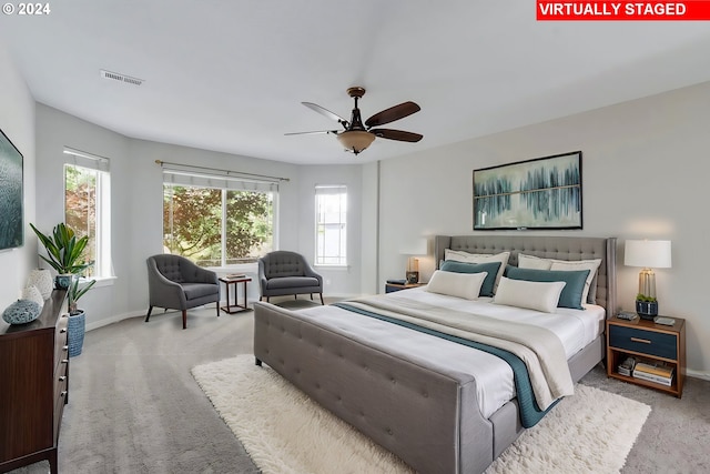 bedroom featuring light colored carpet and ceiling fan