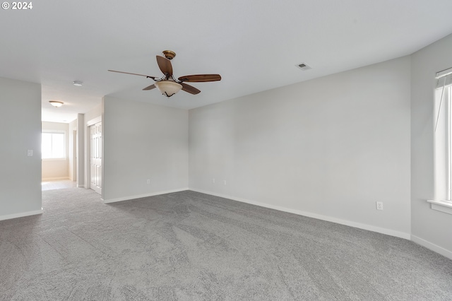 carpeted spare room with ceiling fan