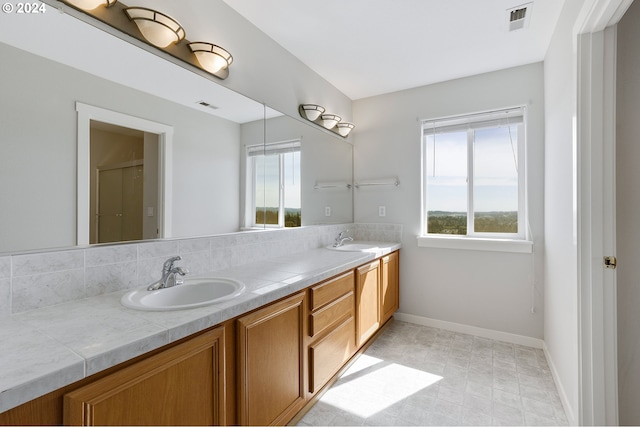 bathroom featuring vanity and a shower with door