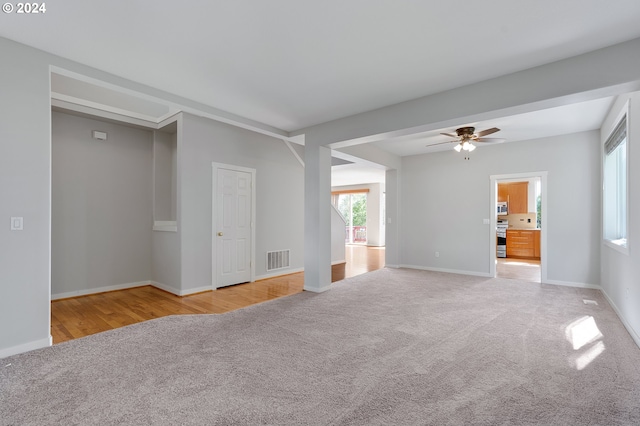 carpeted spare room featuring ceiling fan