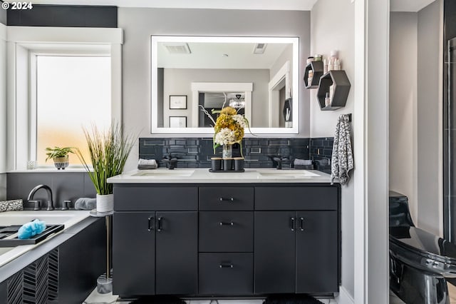 bathroom with vanity and backsplash