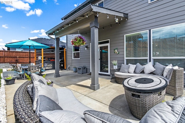 view of patio / terrace with an outdoor living space with a fire pit