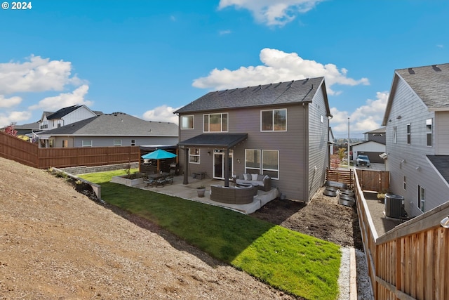 rear view of property with a yard, a patio, central AC unit, and an outdoor hangout area