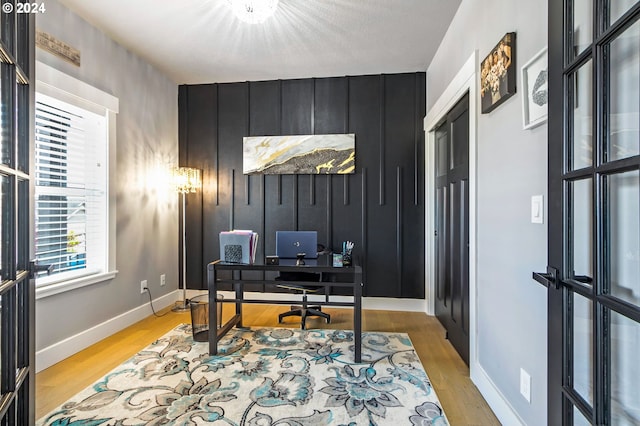 office area with french doors and light hardwood / wood-style flooring