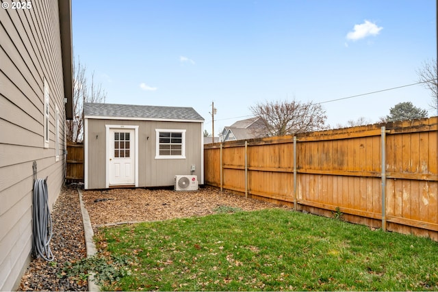 view of yard with ac unit, an outdoor structure, and a fenced backyard