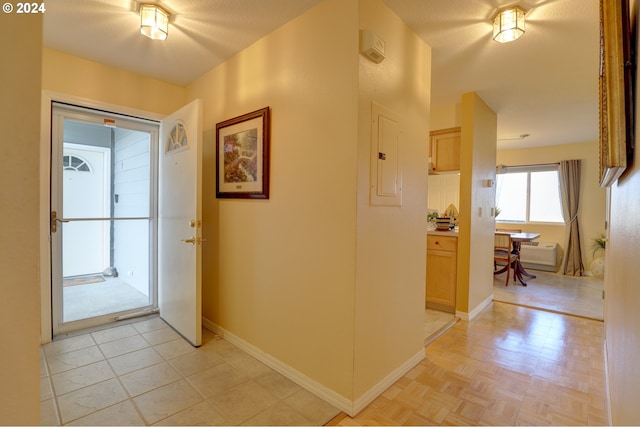 hallway featuring a textured ceiling and electric panel