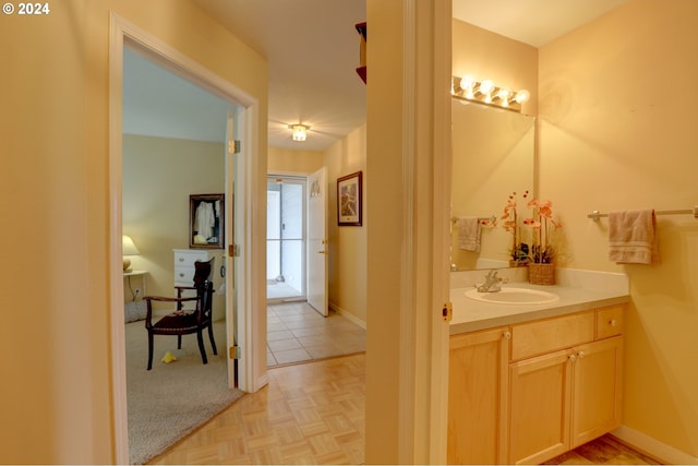 bathroom featuring vanity and parquet flooring