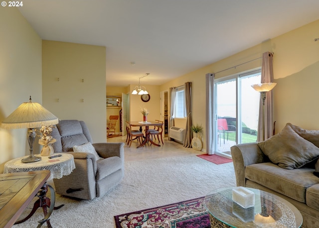 carpeted living room with a wall mounted AC and a chandelier