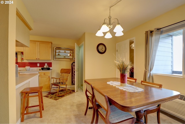 dining area featuring an inviting chandelier