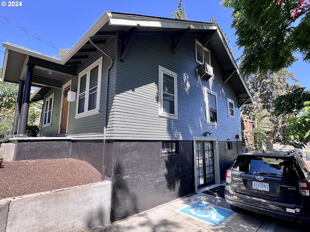 view of side of home featuring cooling unit