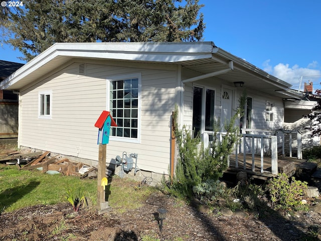 view of property exterior with a wooden deck