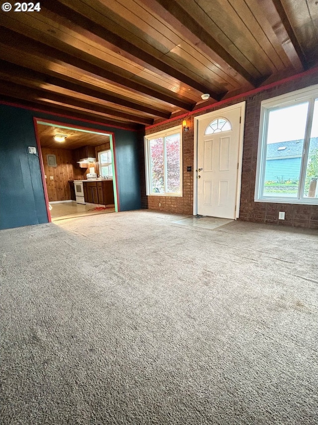 interior space featuring beamed ceiling and carpet floors