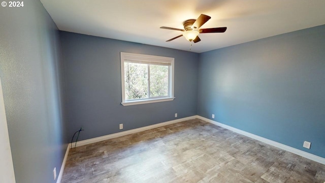 spare room with light hardwood / wood-style flooring and ceiling fan