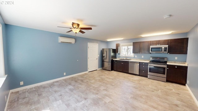 kitchen with a wall unit AC, ceiling fan, sink, light hardwood / wood-style floors, and stainless steel appliances