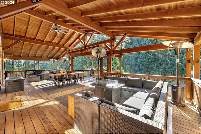 wooden deck featuring an outdoor hangout area and ceiling fan