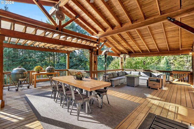 wooden deck with grilling area and an outdoor living space