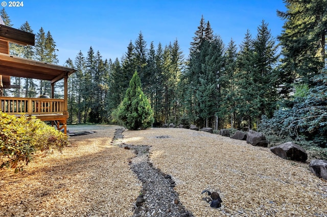 view of yard with a wooden deck