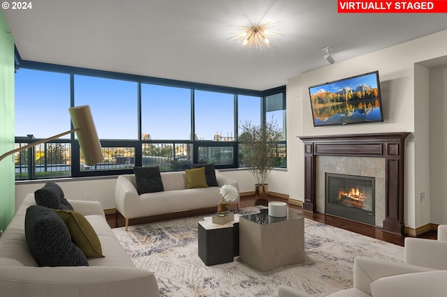 living room with hardwood / wood-style flooring and a tile fireplace