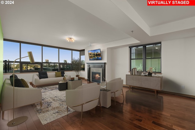 living room featuring expansive windows, hardwood / wood-style flooring, and a healthy amount of sunlight