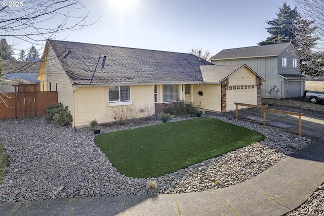 single story home featuring a garage and a front lawn