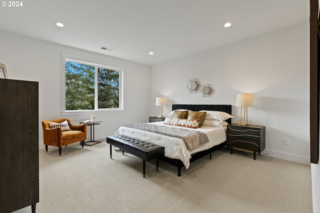 bedroom featuring light carpet