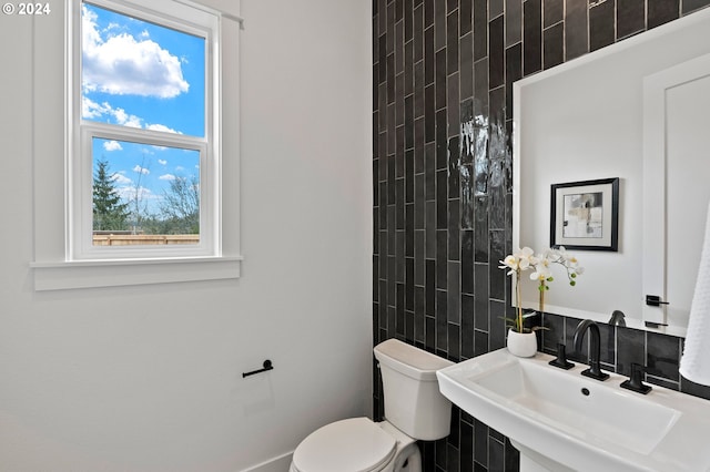 bathroom with plenty of natural light, sink, and toilet