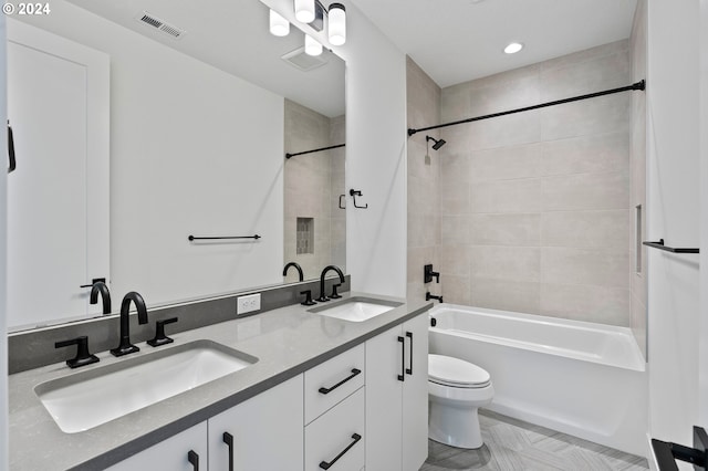 full bathroom with vanity, toilet, and tiled shower / bath